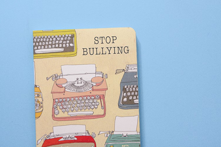 A Stop Bullying book that is on a baby blue background